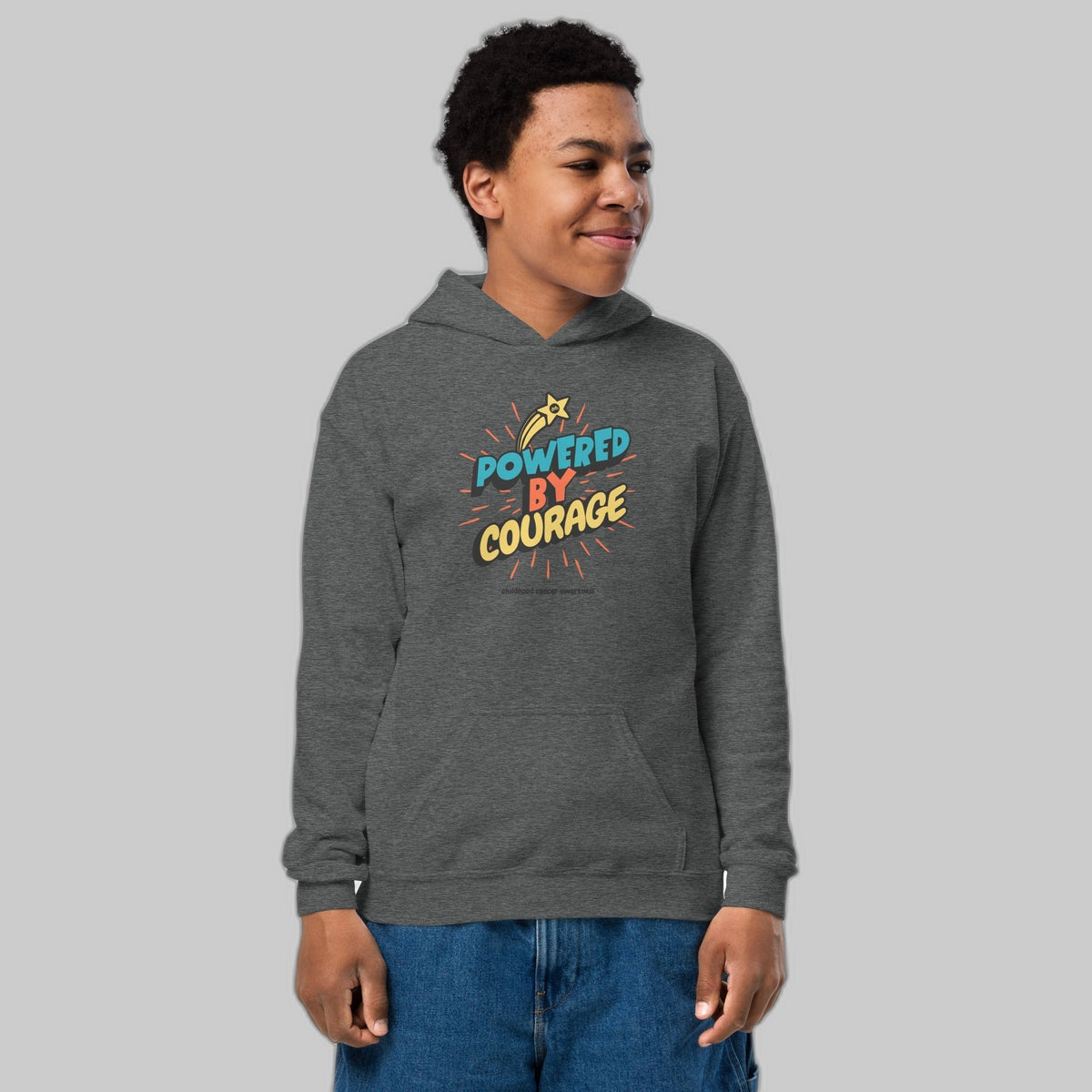 Powered by Courage youth pullover hoodie in Dark Heather, front view, gold shooting-star graphic. Childhood cancer gold ribbon kids apparel from CancerCulture®