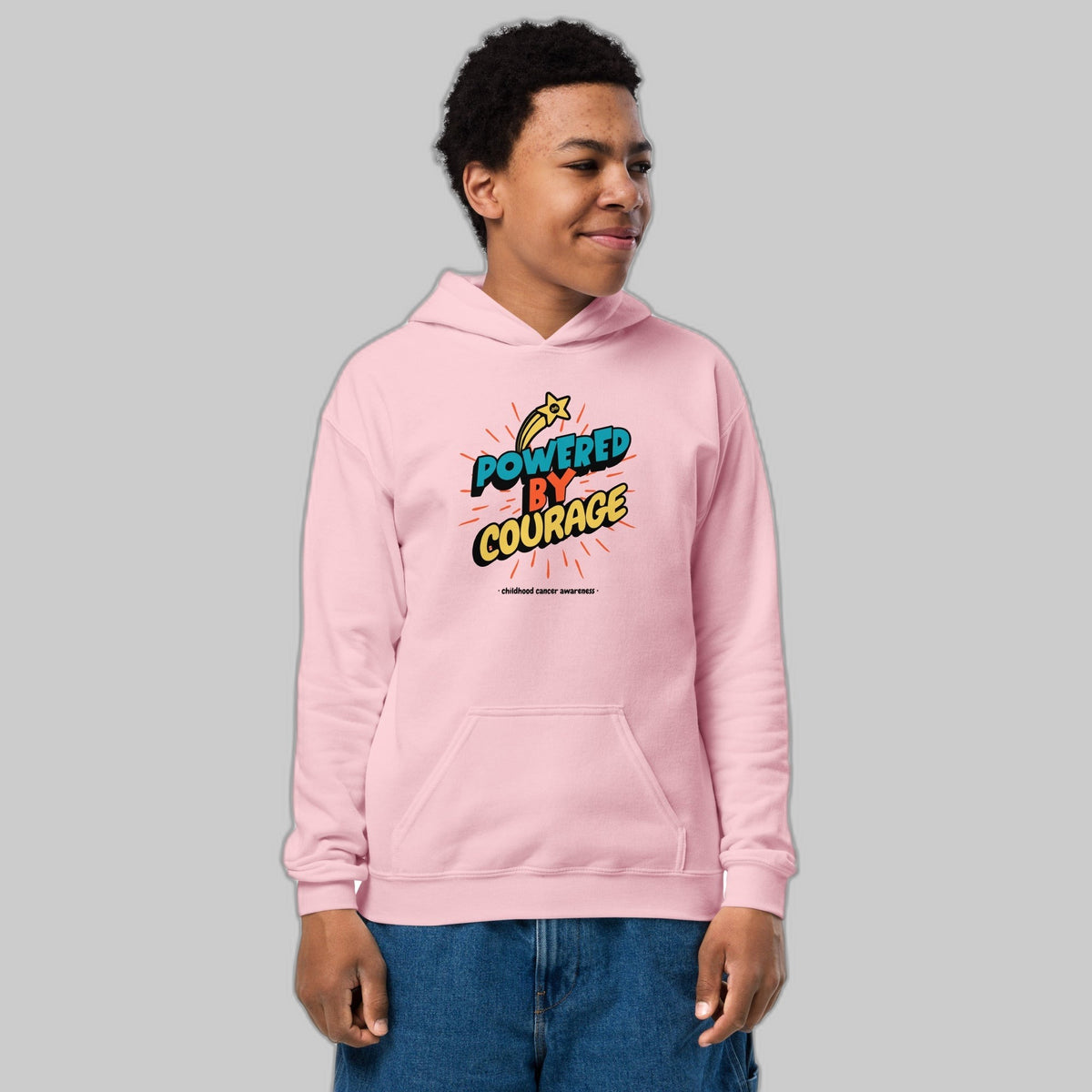 Powered by Courage youth pullover hoodie in Light Pink, front view, gold shooting-star graphic. Childhood cancer gold ribbon kids apparel from CancerCulture®
