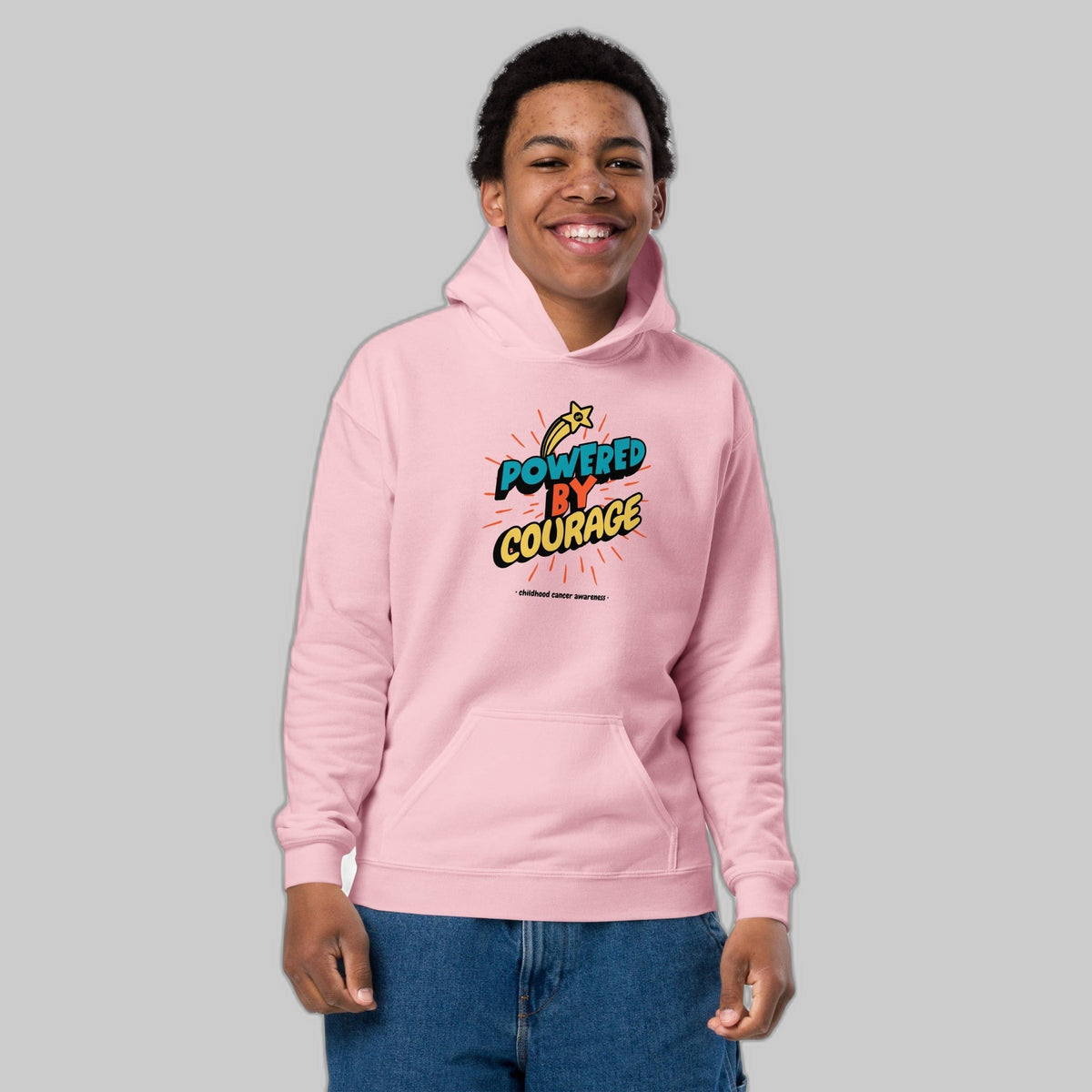 Powered by Courage youth pullover hoodie in Light Pink, front view, gold shooting-star graphic. Childhood cancer gold ribbon kids apparel from CancerCulture®
