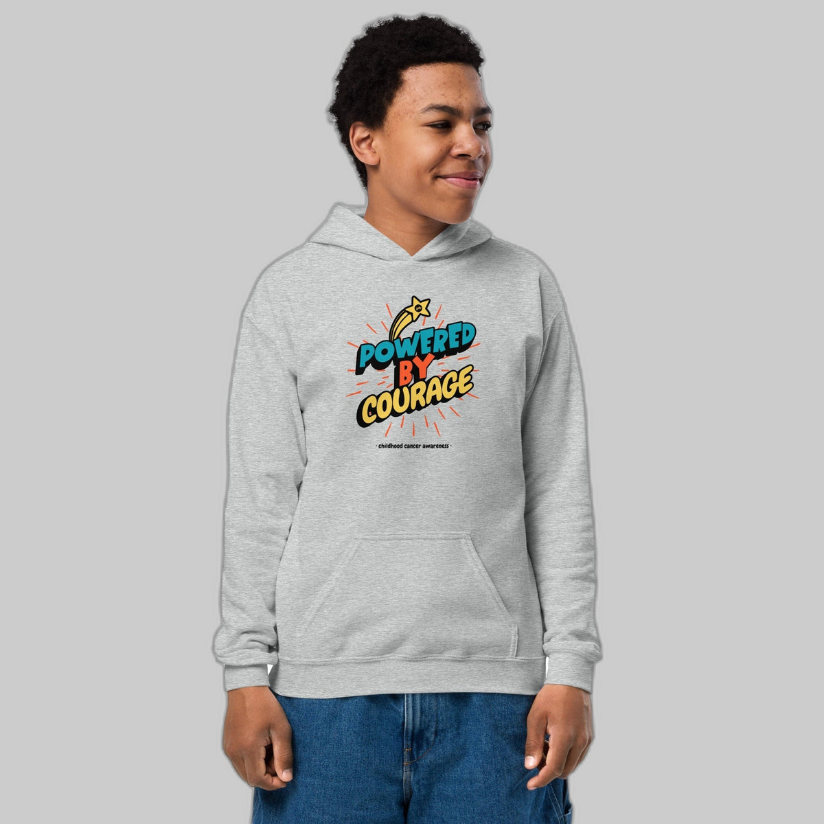 Powered by Courage youth pullover hoodie in Sport Grey, front view, gold shooting-star graphic. Childhood cancer gold ribbon kids apparel from CancerCulture®